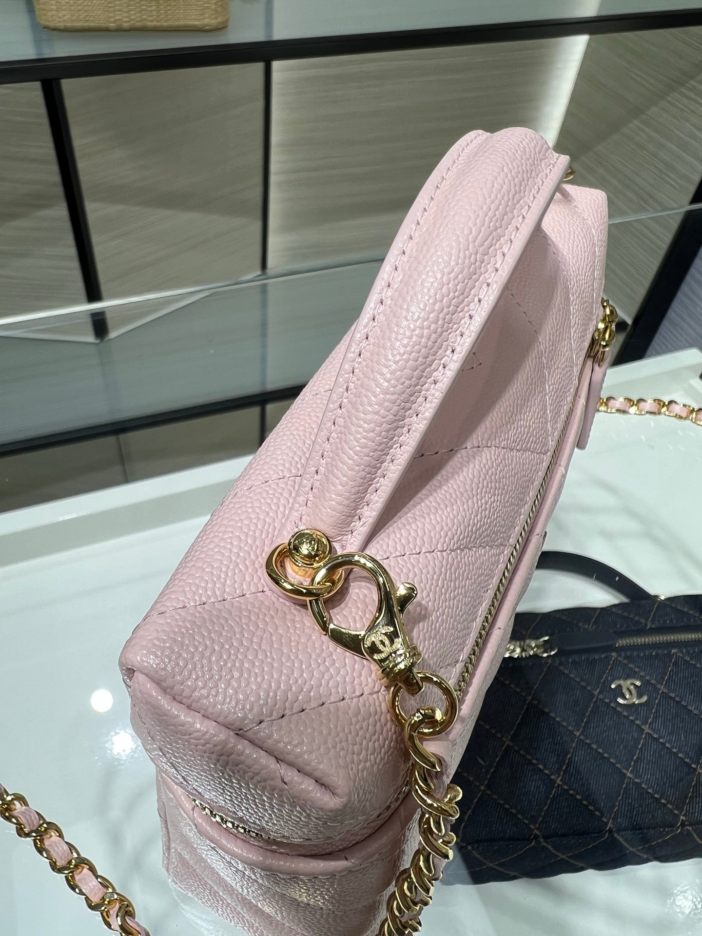 Pink leather shoulder bag with gold chain and heart-shaped key charm