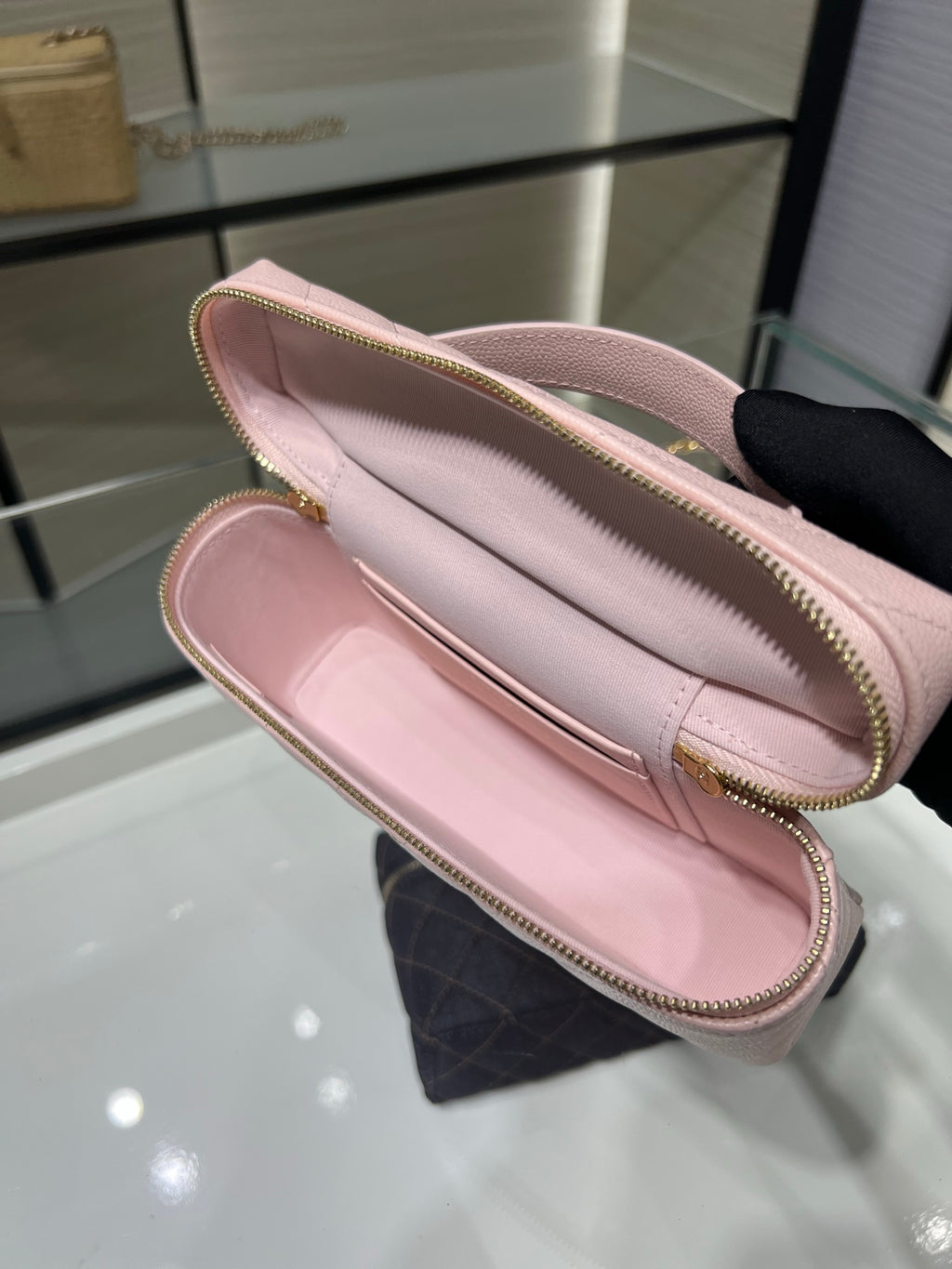 Pink zip-top wallet clutch interior with stitched edges and light lining