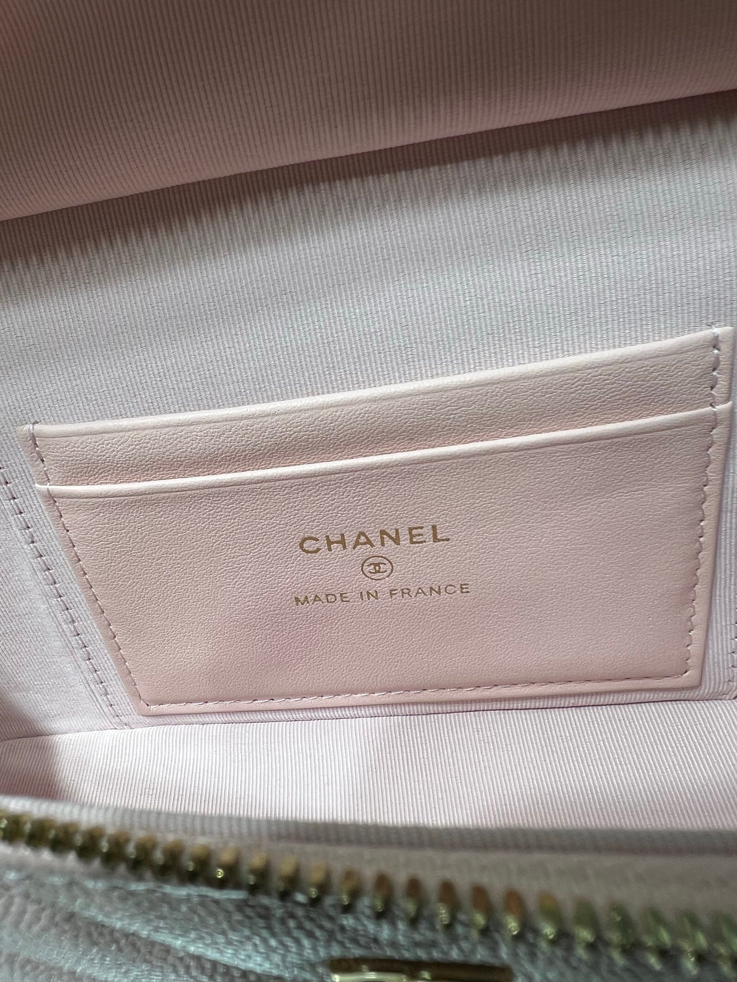 Pink leather bag label reading CHANEL and Made in France