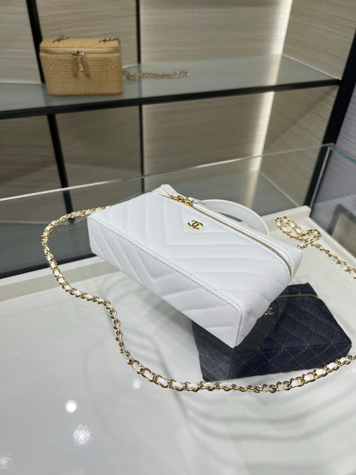 Chanel quilted white bag with chain strap and gold zipper, angled side view