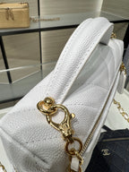 Chanel white leather bag close-up with gold clasp, chain handle, and textured side