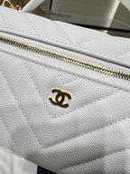 Chanel quilted white bag close-up with gold CC logo on flap