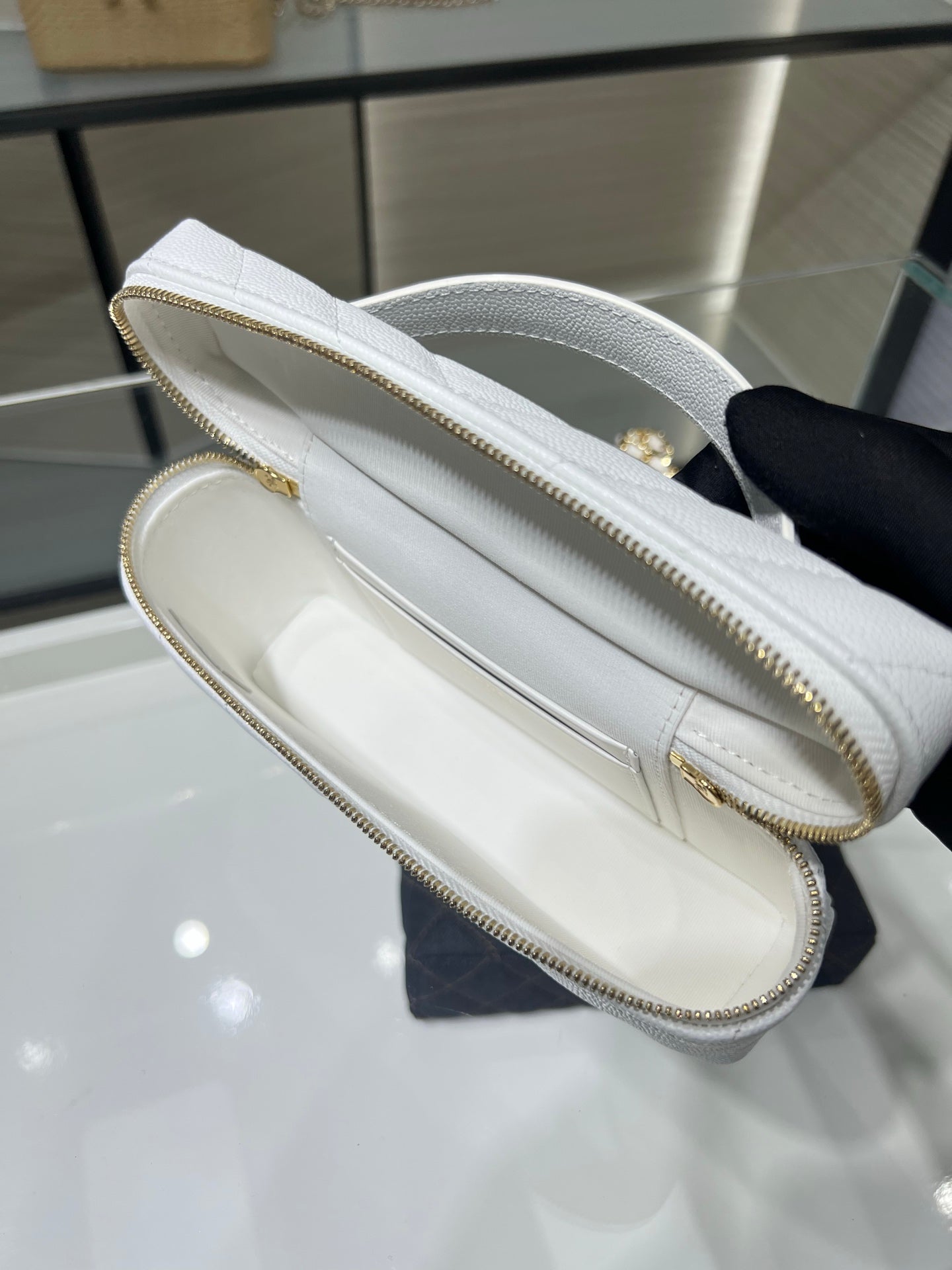 Chanel white quilted bag interior with zip pocket and stitched leather trim