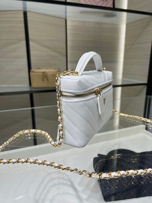 Chanel quilted bag in white with top handle, gold chain strap, and zip closure