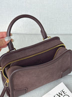 Loewe bag angled view with open top, side zipper, and visible inner lining.