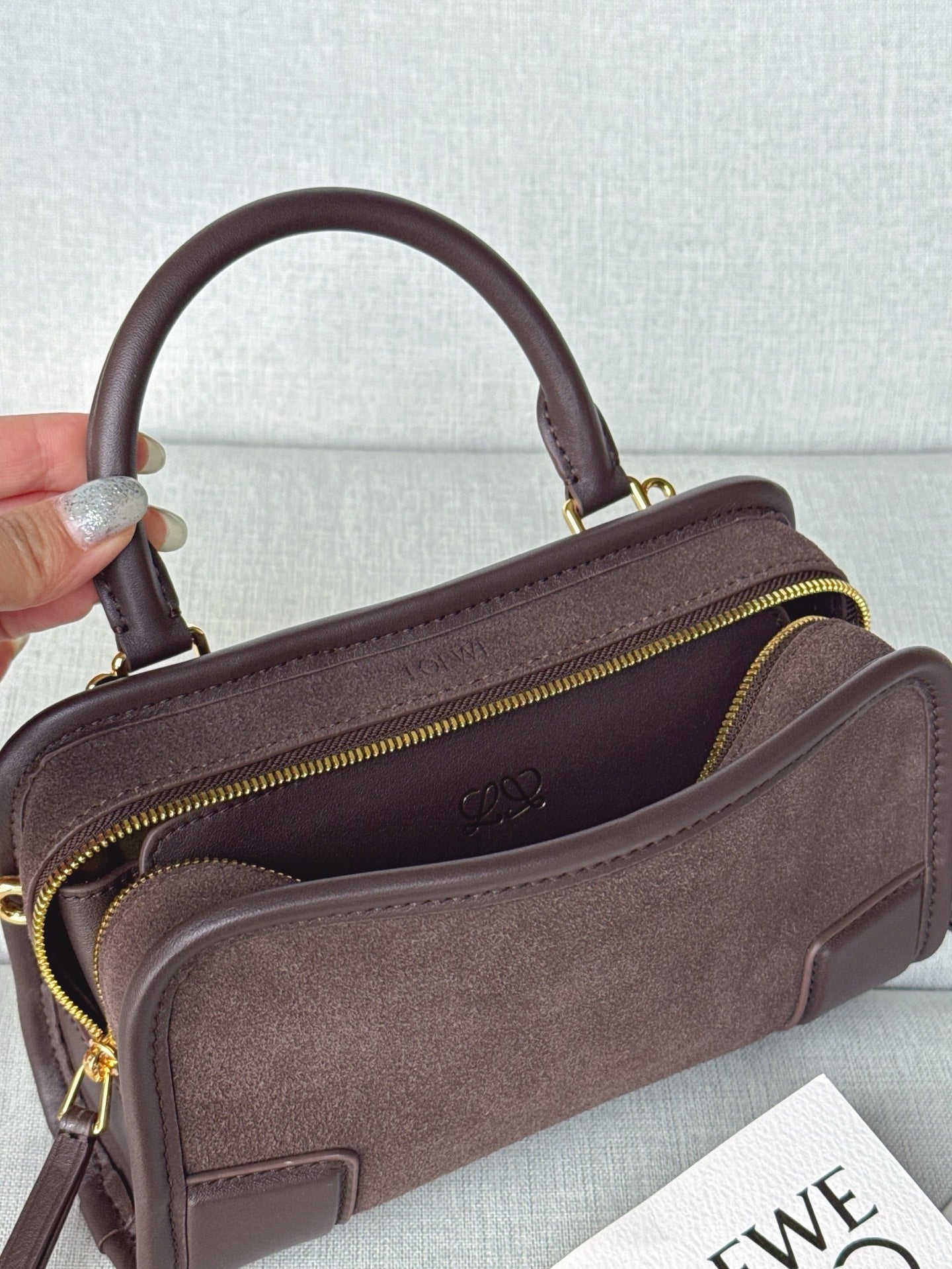 Loewe bag angled view with open top, side zipper, and visible inner lining.