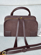 Loewe bag with top handle, front panels, and gold-tone zipper with pull tabs.