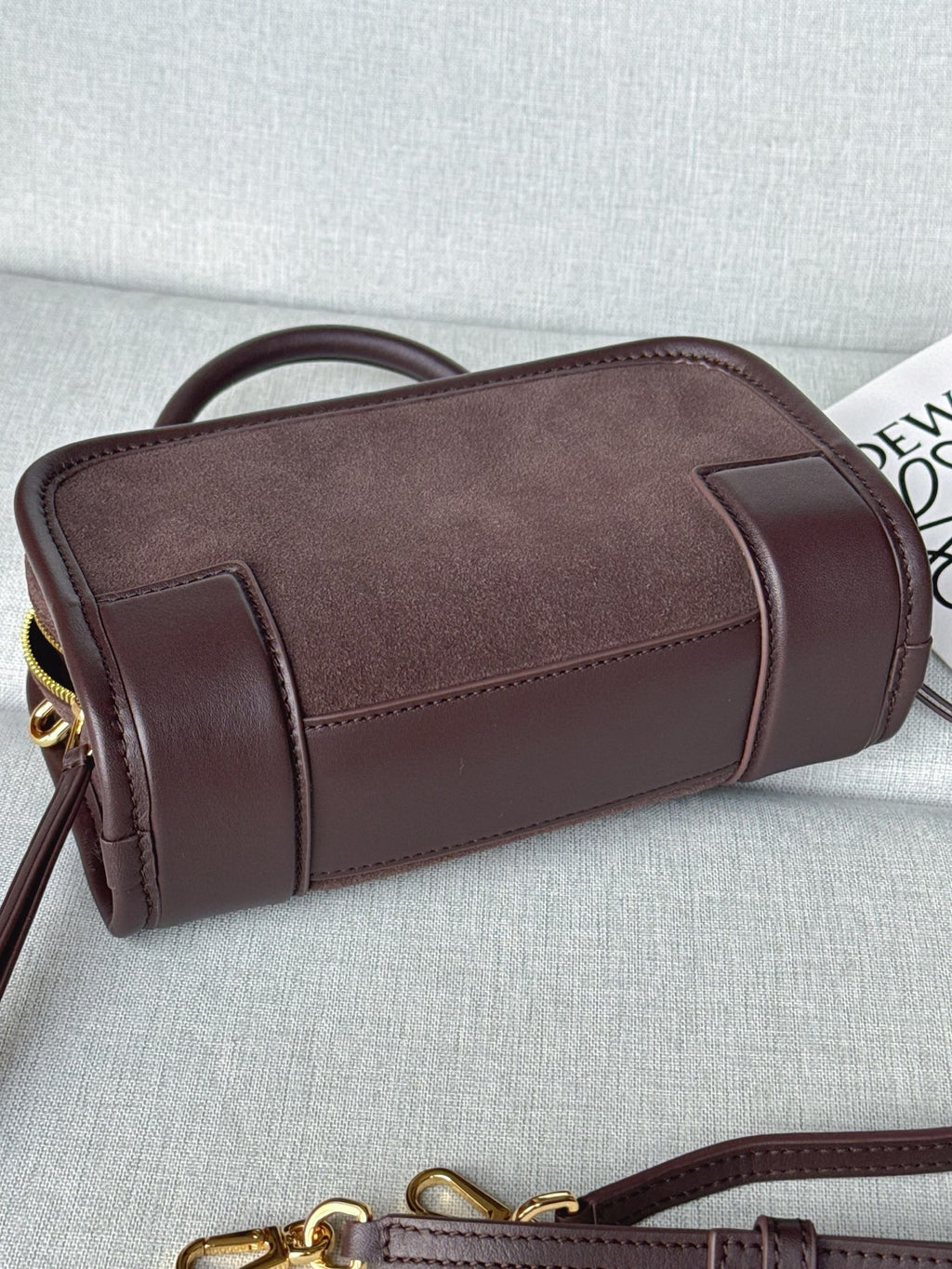 Loewe bag with rolled handles, rounded sides, and gold hardware on the zipper.