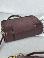 Loewe bag with rolled handles, rounded sides, and gold hardware on the zipper.