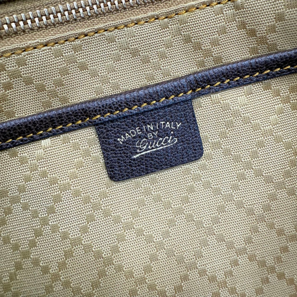 Gucci label reading “MADE IN ITALY” on GG canvas fabric