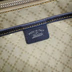 Gucci label reading “MADE IN ITALY” on GG canvas fabric
