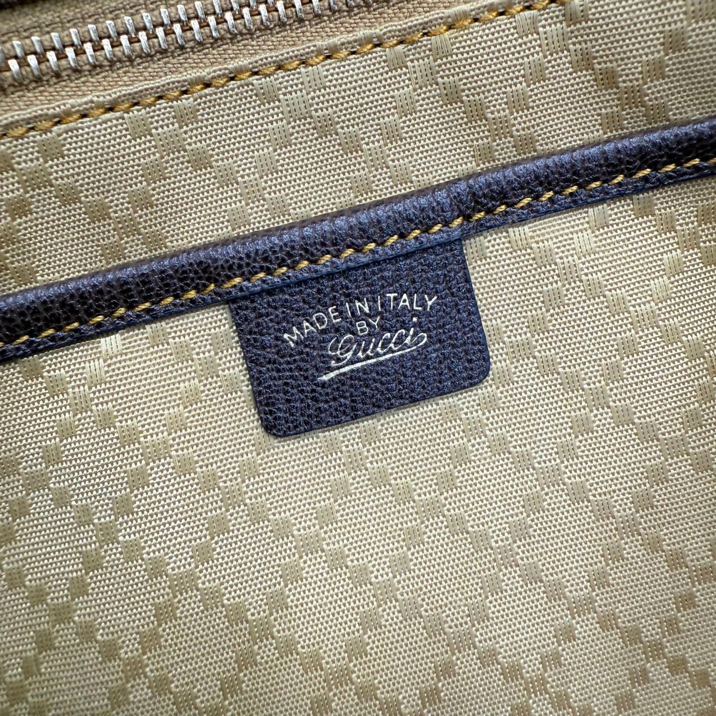 Gucci label reading “MADE IN ITALY” on GG canvas fabric