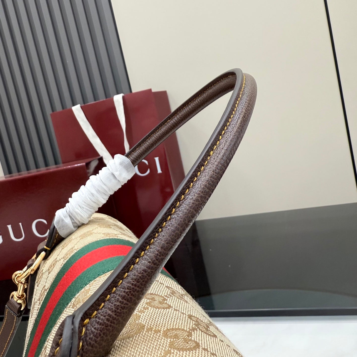 Gucci GG canvas bag with brown leather trim and wrapped top handle