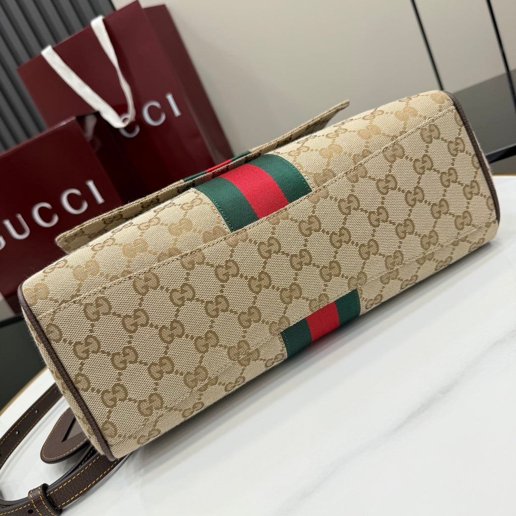 Gucci GG canvas bag with red and green stripe across flap and long shoulder strap