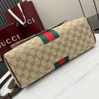 Gucci GG canvas bag with red and green stripe across flap and long shoulder strap