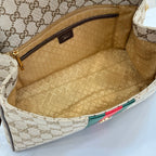 Gucci GG canvas bag interior with beige lining and zippered pocket