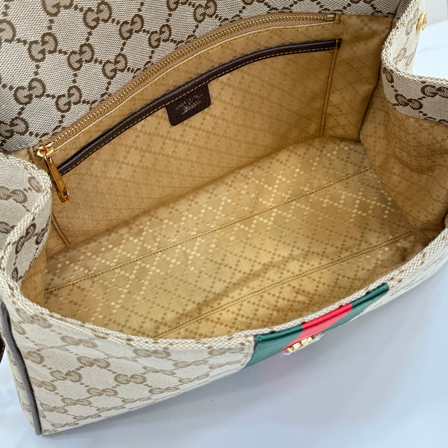 Gucci GG canvas bag interior with beige lining and zippered pocket