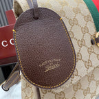 Gucci bag oval leather tag with yellow stitching and “Made in Italy” text