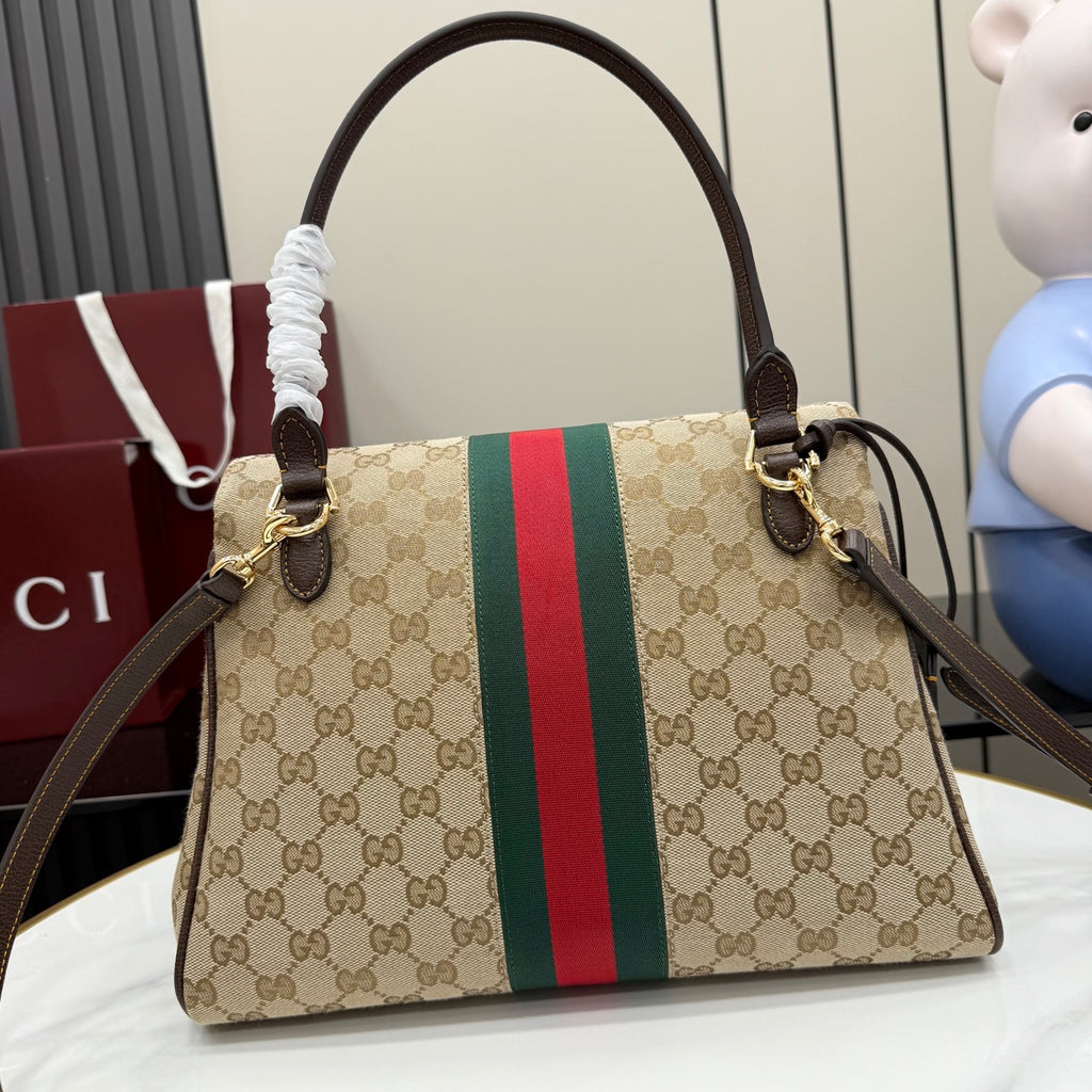 Gucci GG canvas shoulder bag with red and green stripe, front flap, and gold hardware