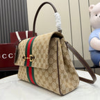 Gucci GG canvas crossbody bag with red and green stripe and brown shoulder strap
