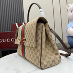 GG-print top-handle bag view with green/red stripe, side pocket, and brown leather strap