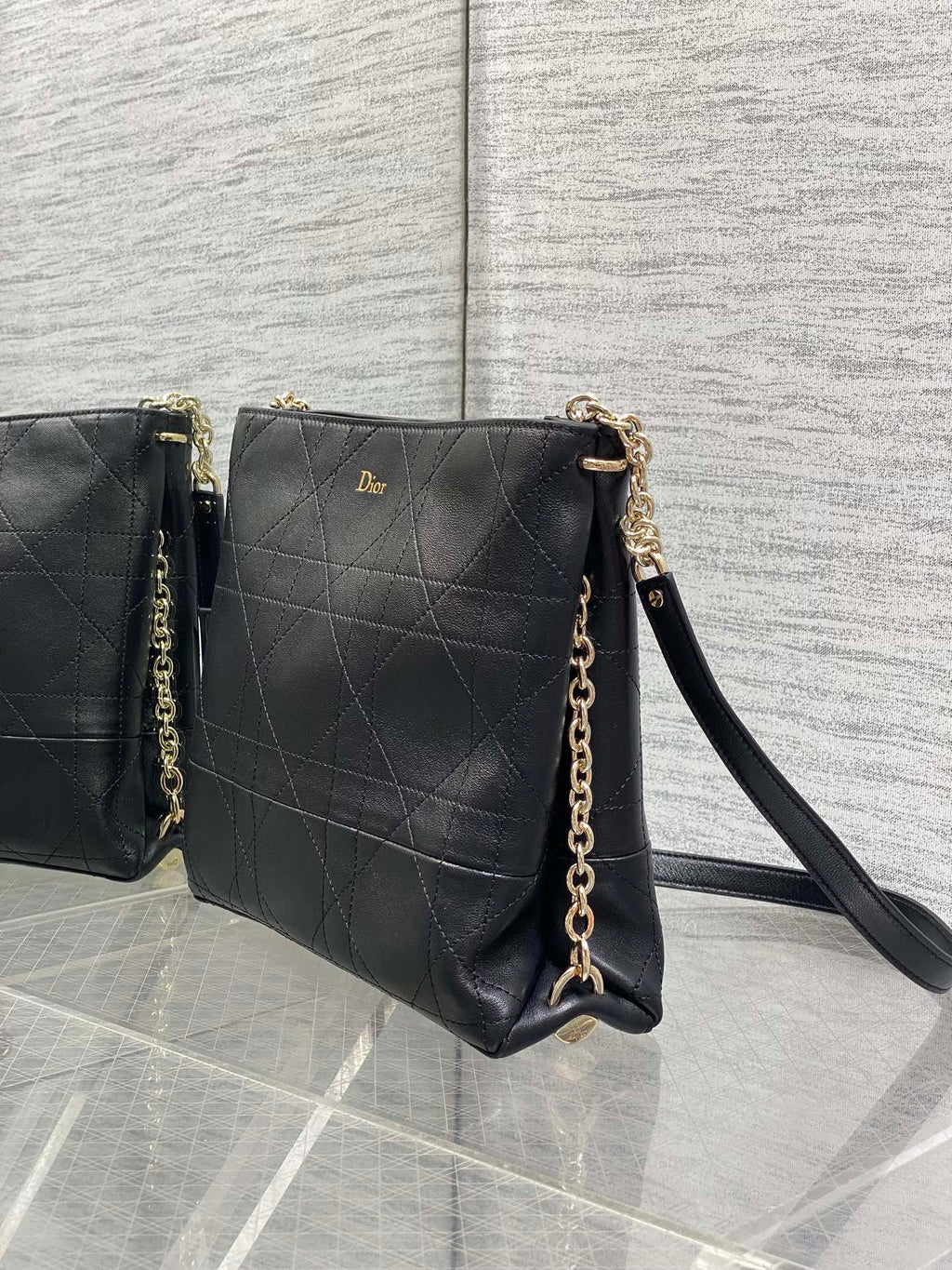 Dior quilted leather crossbody bag with shoulder strap and gold chain, dark.