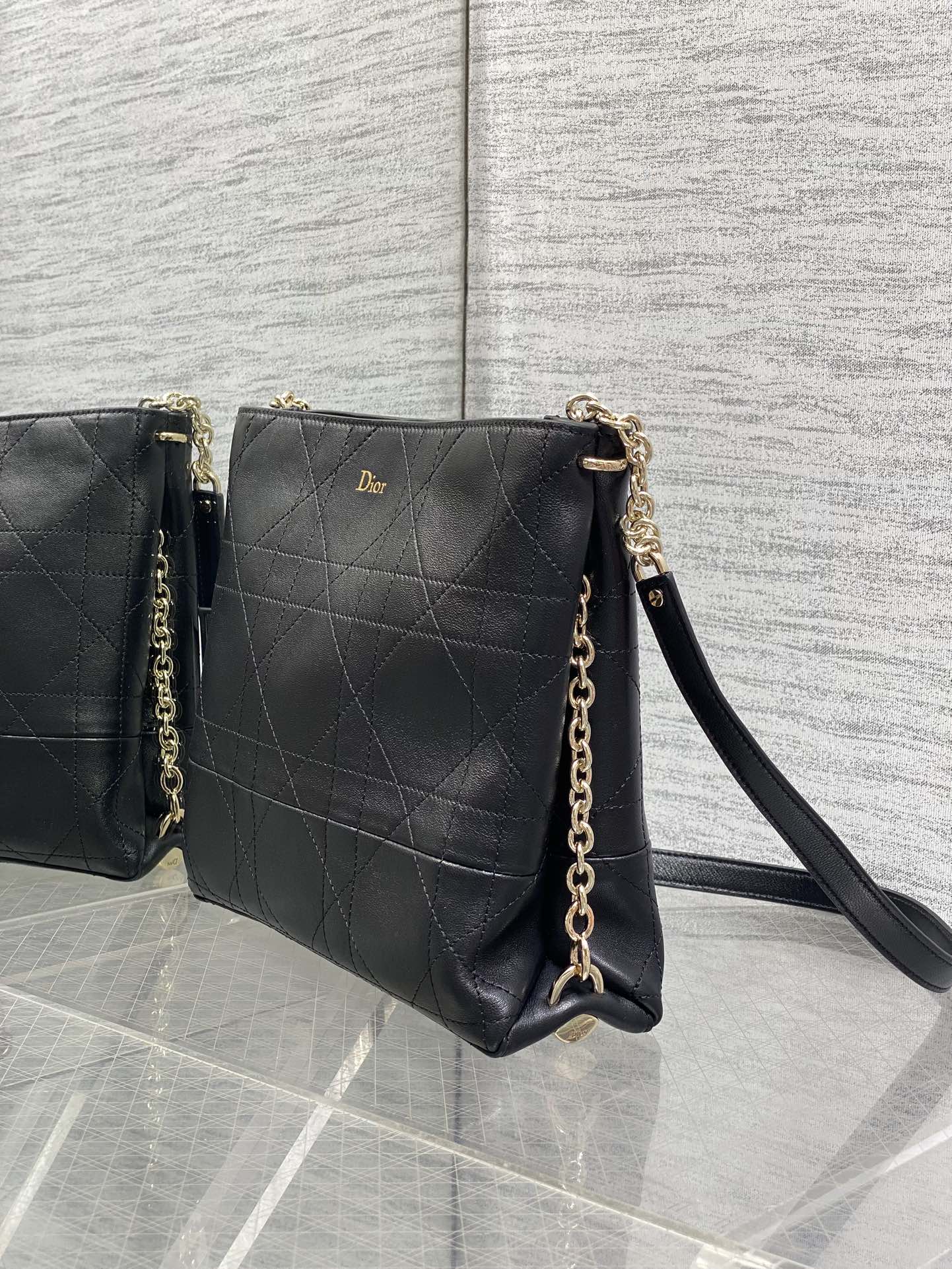 Dior quilted leather crossbody bag with shoulder strap and gold chain, dark.
