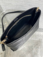 Dior textured leather crossbody bag interior view with gold zipper and chain strap.