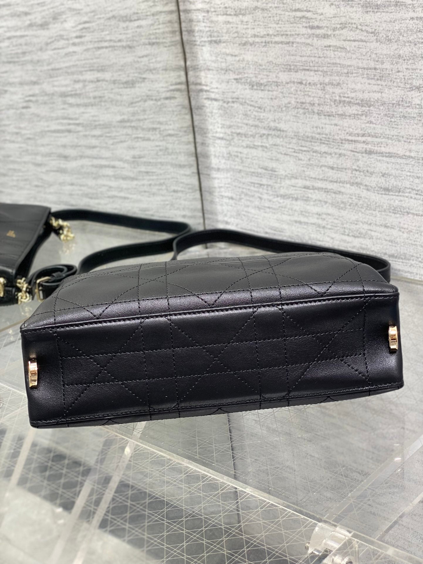Dior quilted leather top-handle bag with chain strap and gold hardware, dark.