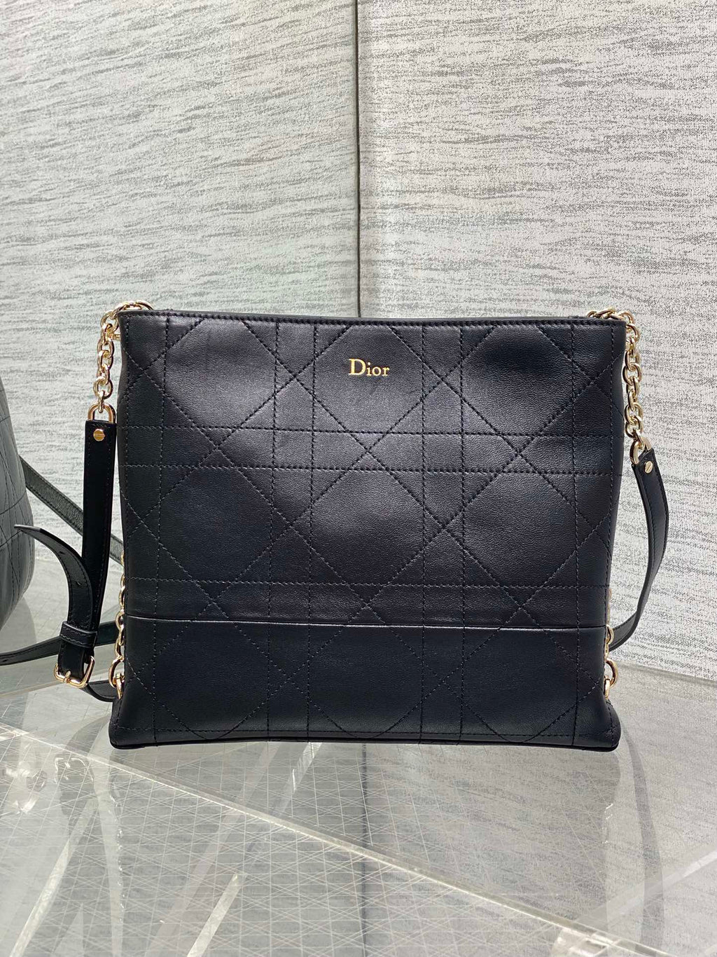 Dior quilted leather crossbody bag with chain strap and flap front, dark navy.