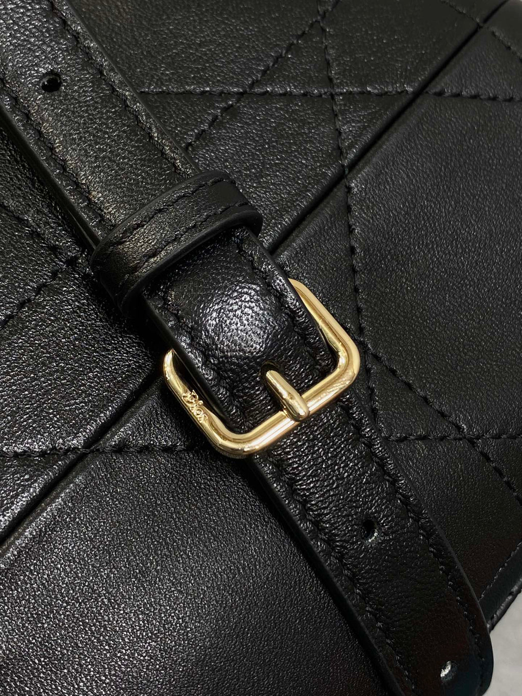 Dior leather bag strap with gold-tone buckle and quilted leather panel, dark.