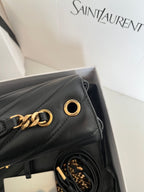 Dark gray leather YSL bag with gold chain hardware and ring clasp detail.
