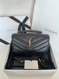 Dark gray quilted leather YSL bag with gold YSL emblem and top handle.