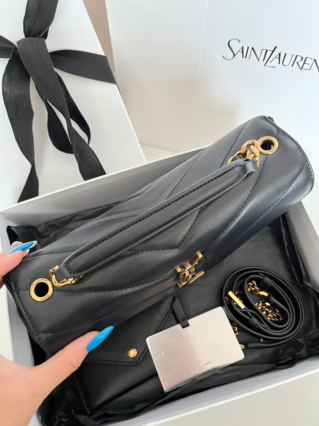 Dark gray leather YSL shoulder bag with gold O-ring chain and chevron quilting.