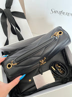 Dark gray leather YSL shoulder bag with gold O-ring chain and chevron quilting.