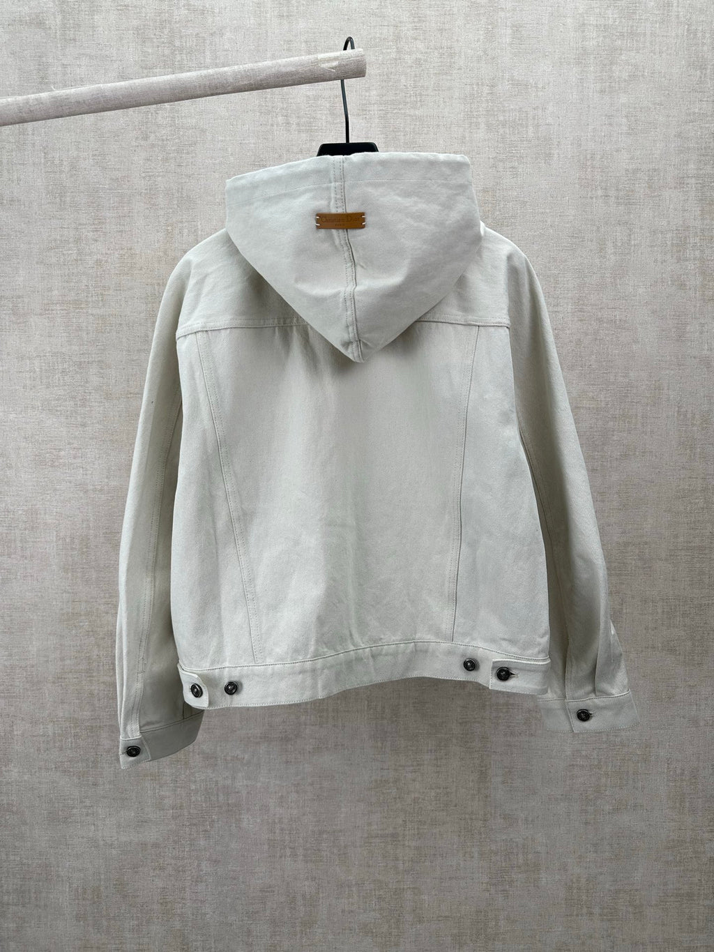 White hooded jacket back view with drawstring and snap hem