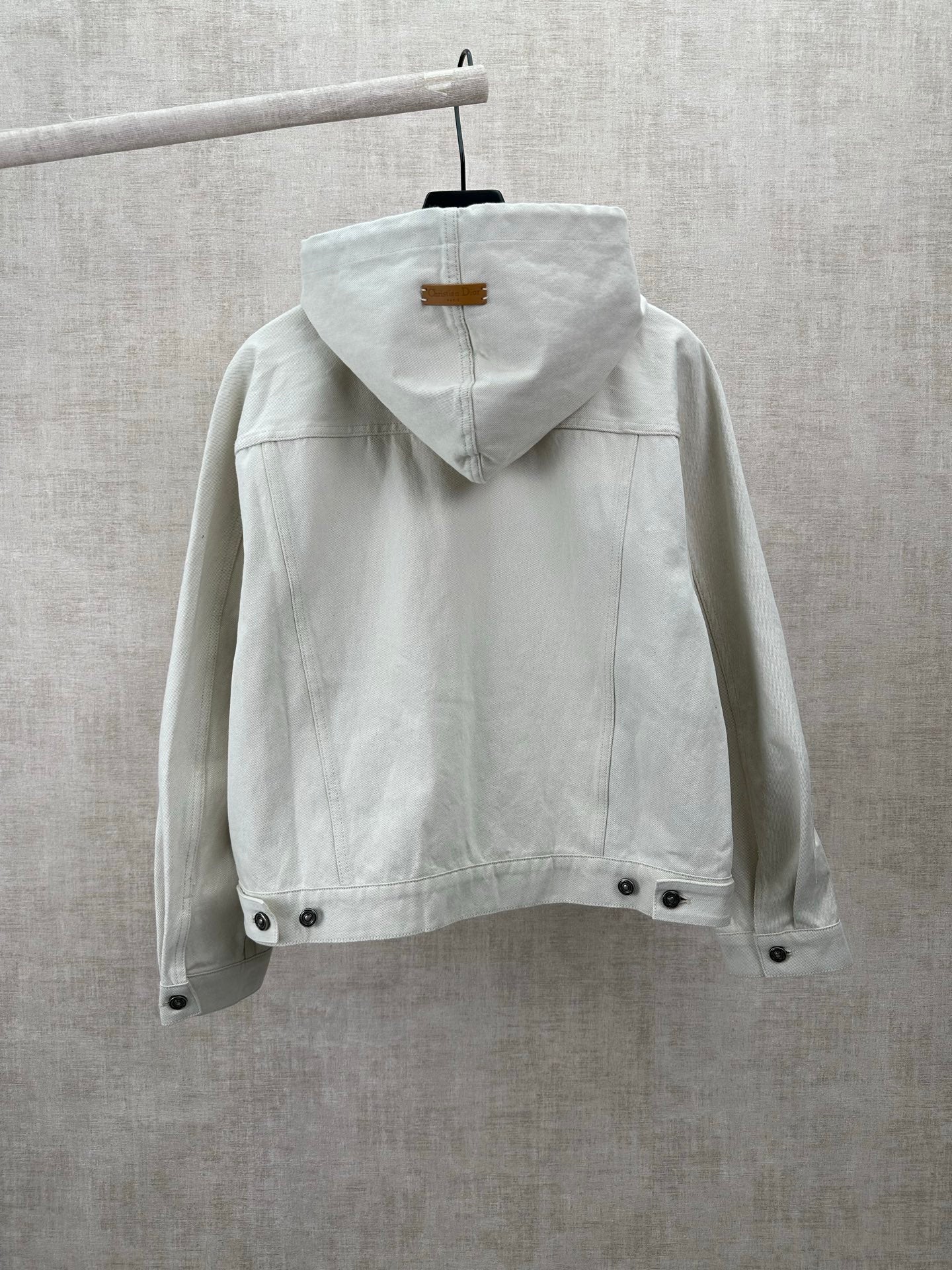 White hooded jacket back view with drawstring and snap hem