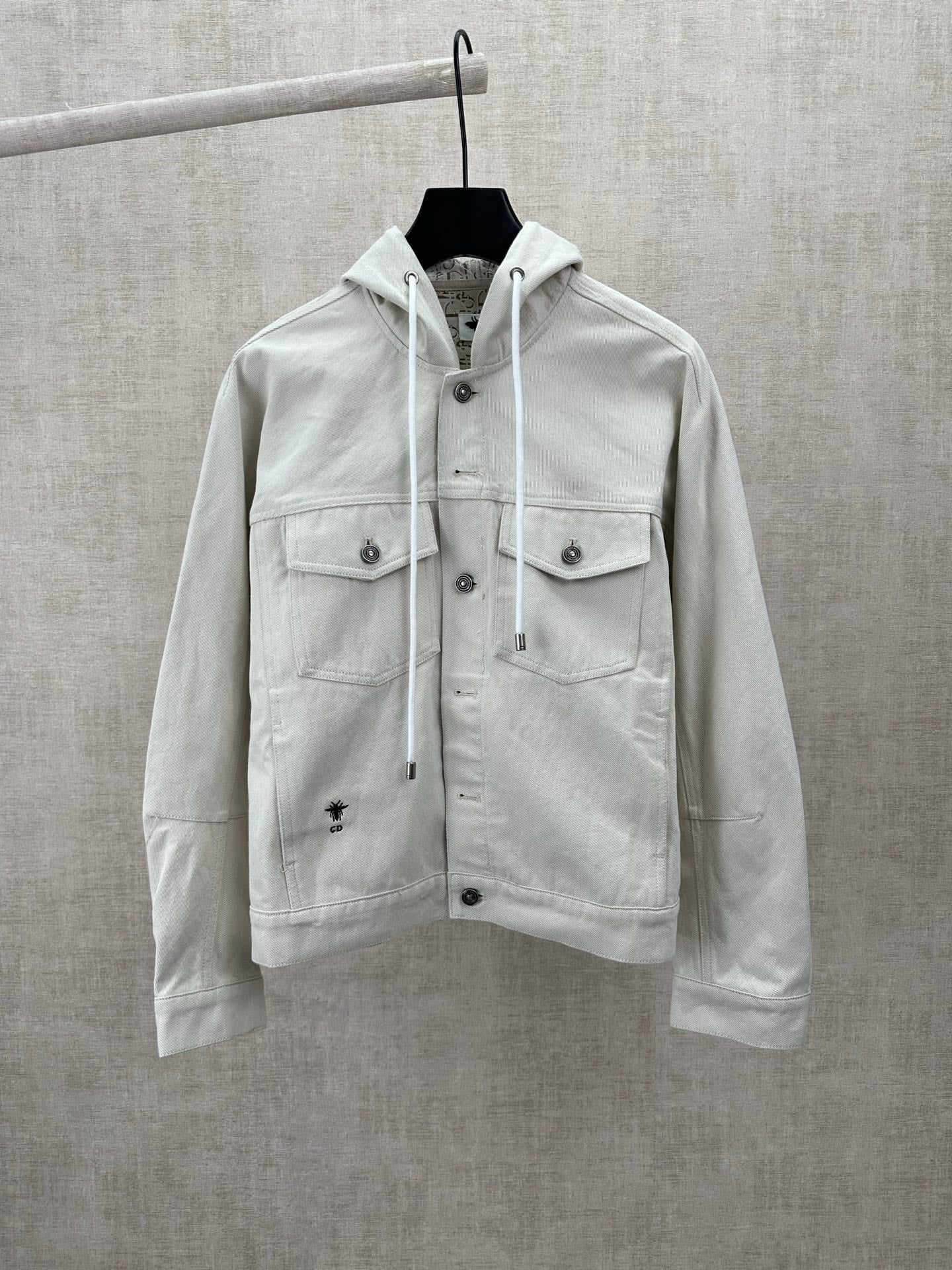 White hooded jacket with drawstring, snap front and chest pockets