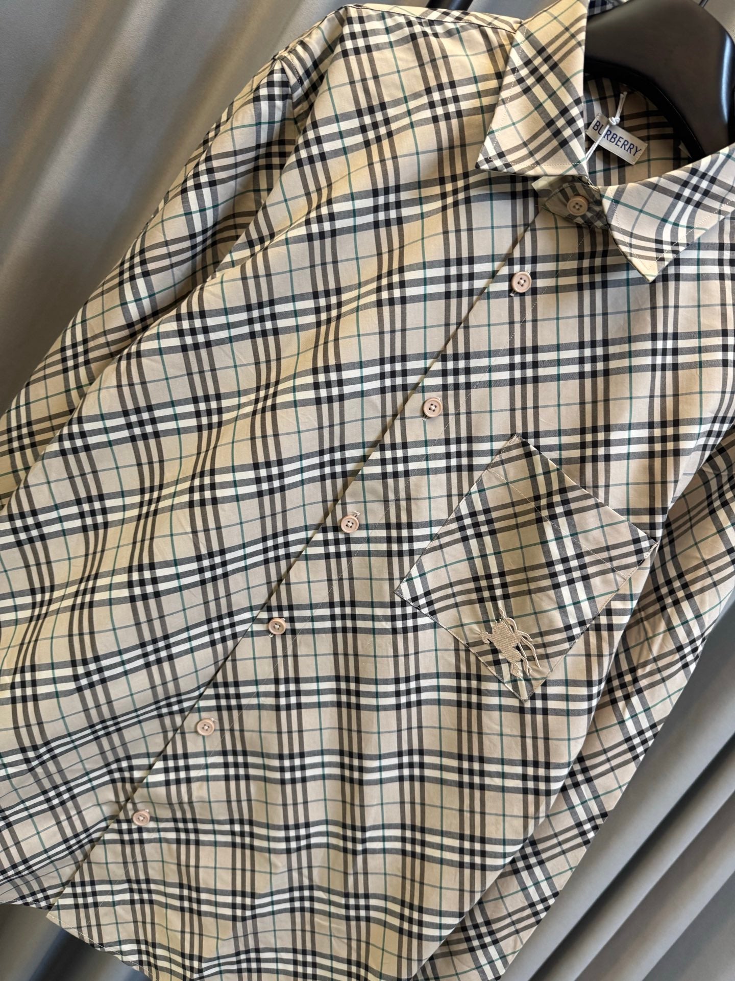 Burberry plaid button-up shirt with flap pocket and diagonal seam detail