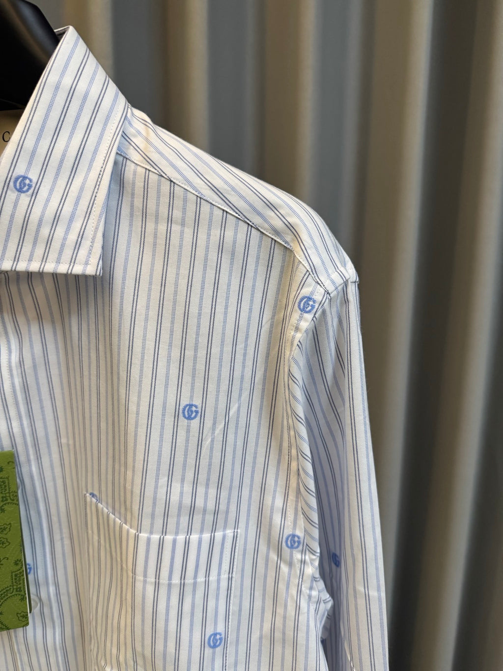 Long-sleeve light striped shirt with blue dot motifs, side view