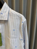 Long-sleeve light striped shirt with blue dot motifs, side view