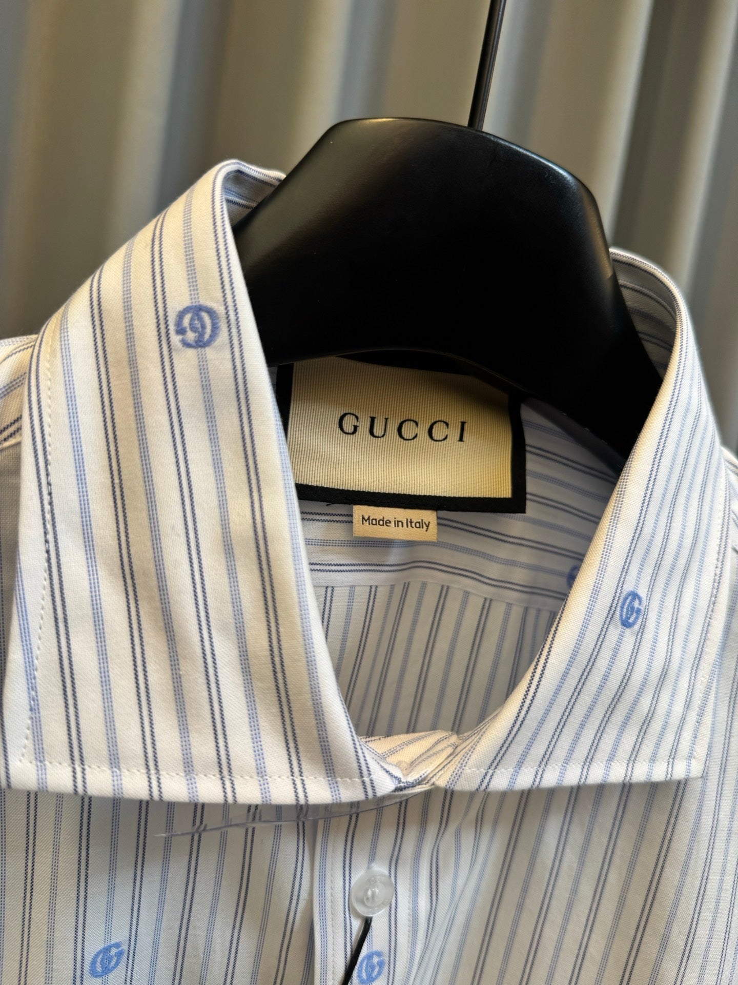 Collared long-sleeve striped shirt with blue dot motifs, interior label visible