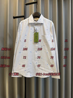 Light striped long-sleeve shirt with blue dot motifs, front view with size markers