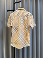 Burberry short-sleeve plaid shirt, buttoned back view in pale yellow and white