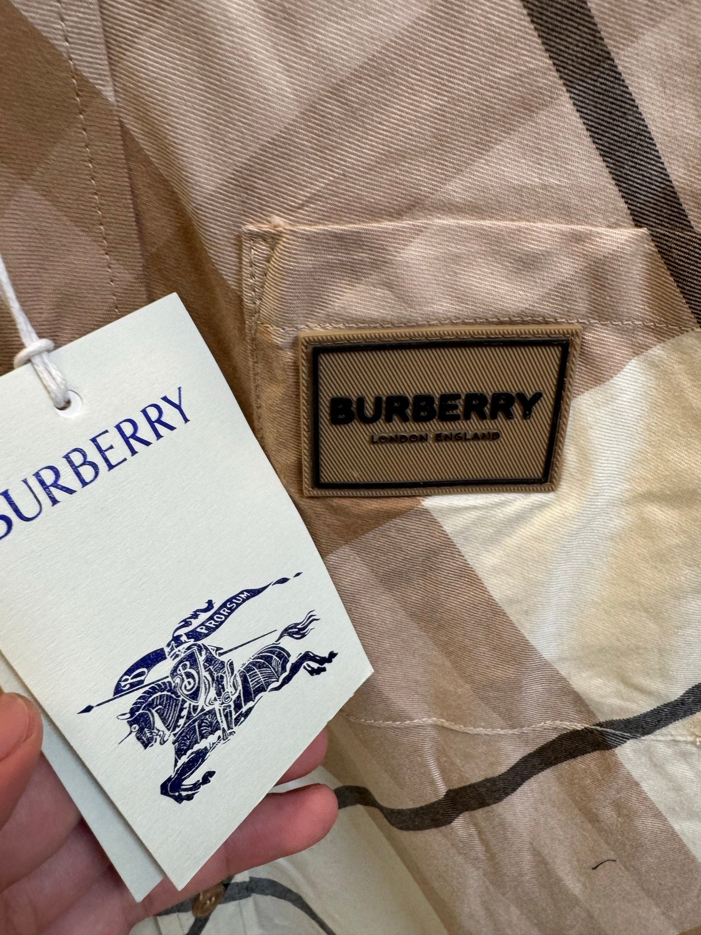 Burberry plaid shirt label detail, beige and navy check with stitched logo patch and tag