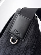 Dior bag front patch with Dior text and silver O-ring on dark navy textile