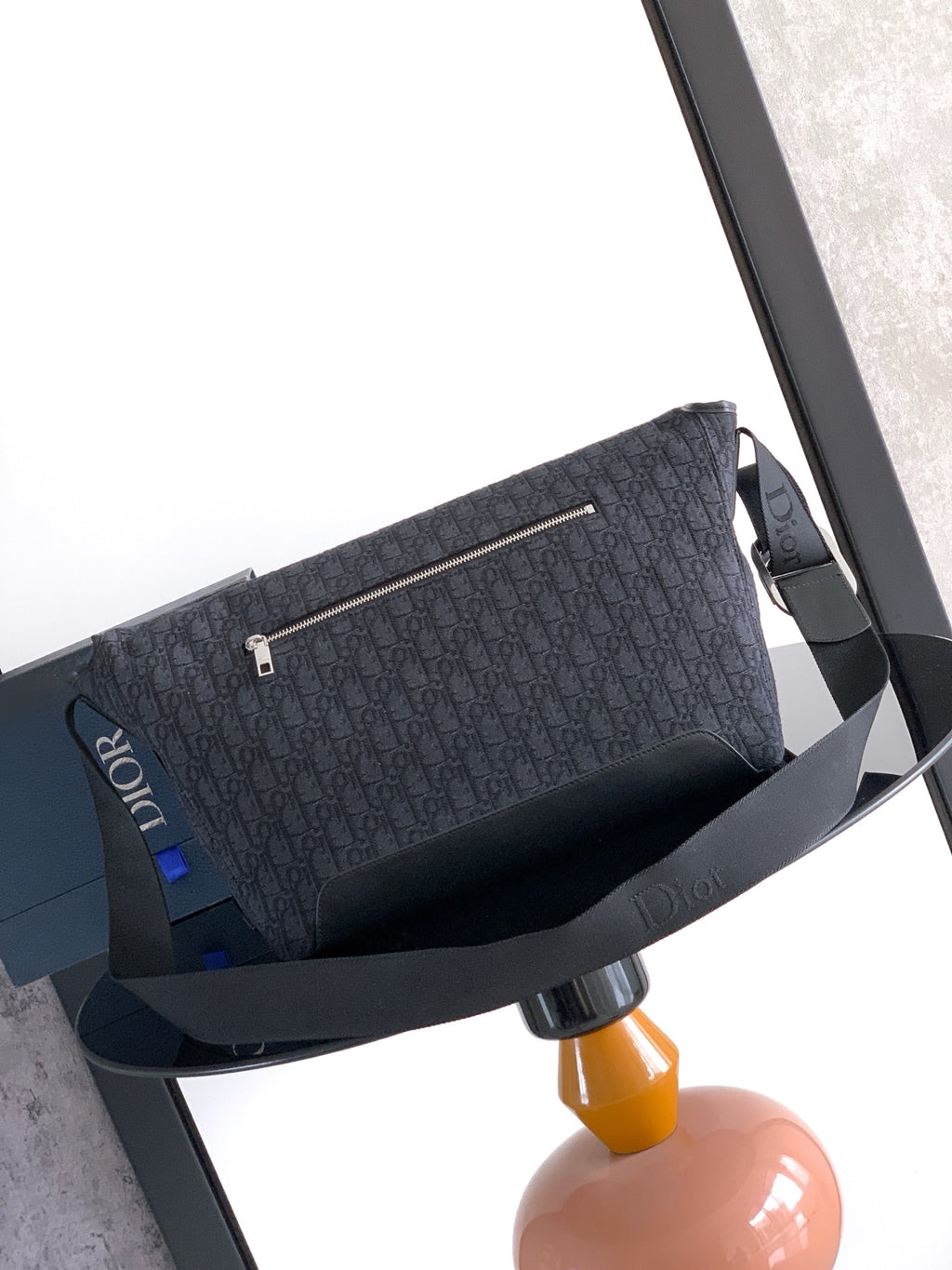Dior shoulder bag with dark navy logo canvas, top strap and long pull tab