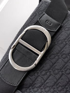 Dior strap detail on dark bag: silver O-ring and textured logo webbing