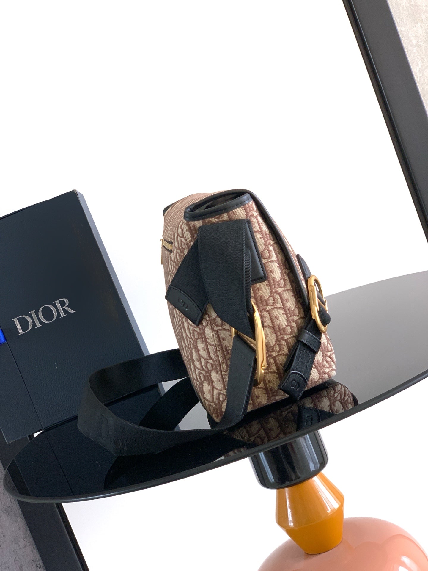 Dior crossbody bag, beige pattern with black strap and flap, gold-tone hardware