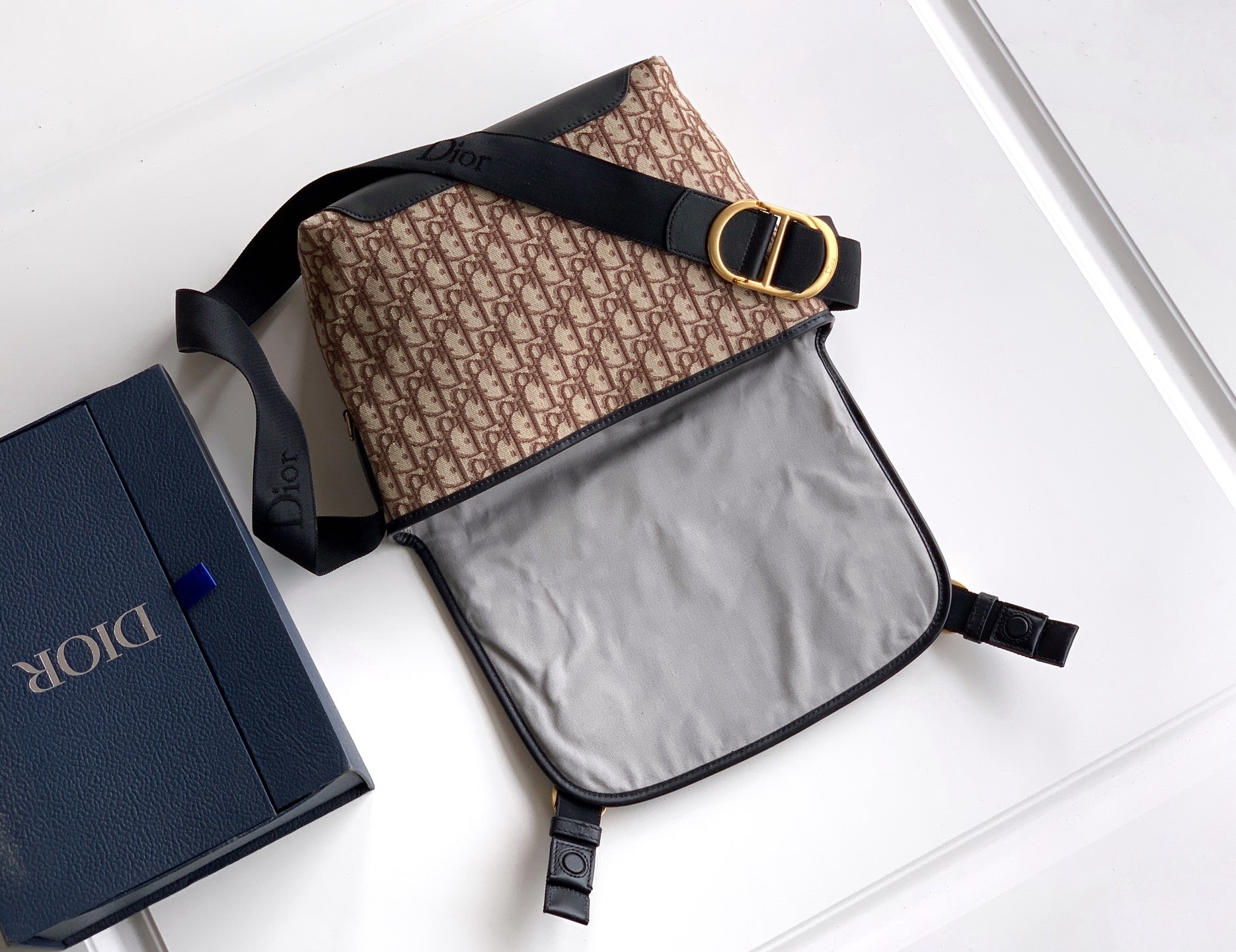 Dior crossbody bag, beige patterned front with black flap and light interior panel